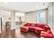 Inviting living room featuring a red sectional couch and an open view to the hallway and staircase at 13204 Feale Ct, Charlotte, NC 28278