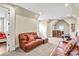 Cozy living room with a leather sofa, neutral carpet, and an adjacent doorway to another room at 13204 Feale Ct, Charlotte, NC 28278