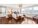 Spacious main bedroom with a four-poster bed, hardwood floors, and plenty of natural light at 13204 Feale Ct, Charlotte, NC 28278