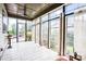 Sunroom with tile floor, ceiling fan, and walls of windows with natural light at 13204 Feale Ct, Charlotte, NC 28278