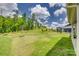 Large, grassy backyard with a view of a wooded area and neighboring homes, showcasing outdoor space at 155 Boxelder Rd, Clover, SC 29710