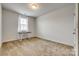An empty carpeted bedroom with neutral walls and a bright window at 155 Boxelder Rd, Clover, SC 29710