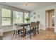 Cozy dining area featuring a rustic table set, three-light pendant and natural light at 155 Boxelder Rd, Clover, SC 29710