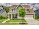 Charming two-story home boasts lush landscaping, a welcoming front porch, and a two-car garage at 155 Boxelder Rd, Clover, SC 29710