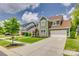Two-story home boasts lush landscaping, a welcoming front porch, and a long driveway at 155 Boxelder Rd, Clover, SC 29710