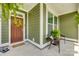 Inviting covered front porch with seating area, ferns, and decorative wreath at the home's entrance at 155 Boxelder Rd, Clover, SC 29710
