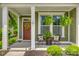 Inviting covered front porch with seating area, ferns, and decorative wreath at the home's entrance at 155 Boxelder Rd, Clover, SC 29710
