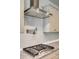 Modern kitchen with stainless hood vent, white subway tile backsplash, gas range, and granite countertop at 155 Boxelder Rd, Clover, SC 29710