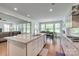 Open-concept kitchen island with granite countertops, stainless appliances, and a view to the living and dining areas at 155 Boxelder Rd, Clover, SC 29710