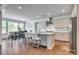 Modern kitchen featuring an island with bar seating, stainless steel appliances, and an adjacent dining area at 155 Boxelder Rd, Clover, SC 29710