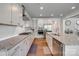 Well-lit kitchen features granite counters, stainless steel appliances, ample cabinetry and hardwood floors at 155 Boxelder Rd, Clover, SC 29710