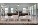 Close-up of a kitchen sink with granite countertops and views to the living area with stairwell at 155 Boxelder Rd, Clover, SC 29710