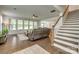 Spacious living room with hardwood floors, a ceiling fan, and large windows overlooking the backyard at 155 Boxelder Rd, Clover, SC 29710