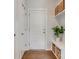 Mudroom showcases a white door with a sidelight, coat hooks and a bench with storage baskets at 155 Boxelder Rd, Clover, SC 29710