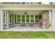 Covered patio with a stone fireplace, ceiling fan, seating area, and large windows overlooking the backyard at 155 Boxelder Rd, Clover, SC 29710