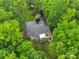 Aerial view of house showing screened porch and lush, mature trees at 1669 Mary Ellen Dr, Fort Mill, SC 29708
