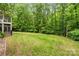 Beautiful backyard featuring a manicured lawn, privacy fence, and mature trees creating a serene outdoor oasis at 1669 Mary Ellen Dr, Fort Mill, SC 29708