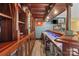 Custom home bar featuring wood trim, shelving, mini fridge, and a serving counter at 1669 Mary Ellen Dr, Fort Mill, SC 29708
