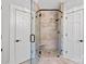 Modern bathroom featuring a glass-enclosed shower with stone tile, a built-in seat, and contrasting black hardware at 1669 Mary Ellen Dr, Fort Mill, SC 29708