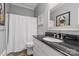 Well-lit bathroom featuring a granite countertop, modern faucet, and stylish decor in a gray color scheme at 1669 Mary Ellen Dr, Fort Mill, SC 29708