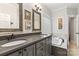 Bathroom with a double sink vanity, decorative mirrors, and a built-in tub with tile surround at 1669 Mary Ellen Dr, Fort Mill, SC 29708