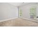 Bright and airy bedroom with natural light, two windows with blinds and neutral carpeting at 1669 Mary Ellen Dr, Fort Mill, SC 29708