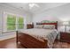 Cozy bedroom with hardwood floors, natural light from a large window, and a decorative bed frame at 1669 Mary Ellen Dr, Fort Mill, SC 29708