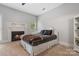 Cozy bedroom featuring a fireplace with a decorative mantel, a comfortable bed, and soft natural light at 1669 Mary Ellen Dr, Fort Mill, SC 29708