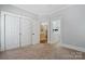 Spacious bedroom with neutral carpeting and a view into the bathroom at 1669 Mary Ellen Dr, Fort Mill, SC 29708