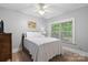 Bright bedroom with a ceiling fan, window overlooking a beautiful yard, and comfortable furniture at 1669 Mary Ellen Dr, Fort Mill, SC 29708