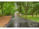 Long paved driveway leading to a charming home surrounded by mature trees at 1669 Mary Ellen Dr, Fort Mill, SC 29708