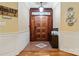 Inviting foyer features tile and hardwood flooring and a beautiful wooden front door at 1669 Mary Ellen Dr, Fort Mill, SC 29708