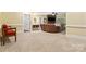 Open living room with plush carpet, a stone fireplace and entertainment center and recessed lighting at 1669 Mary Ellen Dr, Fort Mill, SC 29708