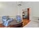 Living room with wood floors, fireplace, sitting chairs, sofa, and modern chandelier at 1669 Mary Ellen Dr, Fort Mill, SC 29708