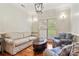 Bright living room featuring hardwood floors, furniture seating, and a window view to exterior yard at 1669 Mary Ellen Dr, Fort Mill, SC 29708