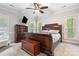 Comfortable main bedroom with carpet, ceiling fan, and a large wooden bed with natural light at 1669 Mary Ellen Dr, Fort Mill, SC 29708