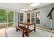 Charming sunroom with a ceiling fan, dining table, and views of the lush green yard at 1669 Mary Ellen Dr, Fort Mill, SC 29708