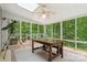 Bright sunroom with skylights, a dining table and bench, and views of the surrounding greenery at 1669 Mary Ellen Dr, Fort Mill, SC 29708