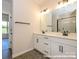 Modern bathroom with double vanity, sleek fixtures, and a glass-enclosed shower at 17033 Malone Ln, Mint Hill, NC 28227