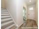 Bright entryway showcasing a staircase, wood flooring, and a stylish front door at 17033 Malone Ln, Mint Hill, NC 28227
