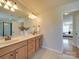 This primary bathroom features double sinks, a large mirror, and a separate glass-enclosed shower at 1708 Aringill Ln, Matthews, NC 28104