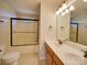 Bathroom featuring double sink vanity with a shower behind a glass enclosure at 1708 Aringill Ln, Matthews, NC 28104