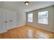 Bedroom with hardwood floors, double closet, and lots of natural light at 1708 Aringill Ln, Matthews, NC 28104