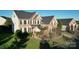 Exterior shot of brick home, featuring manicured lawn and lush landscaping, enhancing curb appeal at 1708 Aringill Ln, Matthews, NC 28104