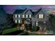 Stately brick home with manicured lawn, showcasing elegant curb appeal during twilight at 1708 Aringill Ln, Matthews, NC 28104