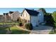 Beautiful exterior elevation features a brick and vinyl siding, lush lawn, and a two-car garage at 1708 Aringill Ln, Matthews, NC 28104