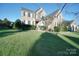 Charming brick home with well-kept lawn, showcasing beautiful landscaping and classic architectural details at 1708 Aringill Ln, Matthews, NC 28104