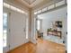 Light and bright foyer with hardwood floors and a study or den to the left at 1708 Aringill Ln, Matthews, NC 28104