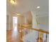The well-lit upstairs hallway features hardwood floors and leads to multiple bedrooms at 1708 Aringill Ln, Matthews, NC 28104