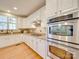 Close-up of the bright kitchen with granite counters and stainless appliances and double ovens at 1708 Aringill Ln, Matthews, NC 28104